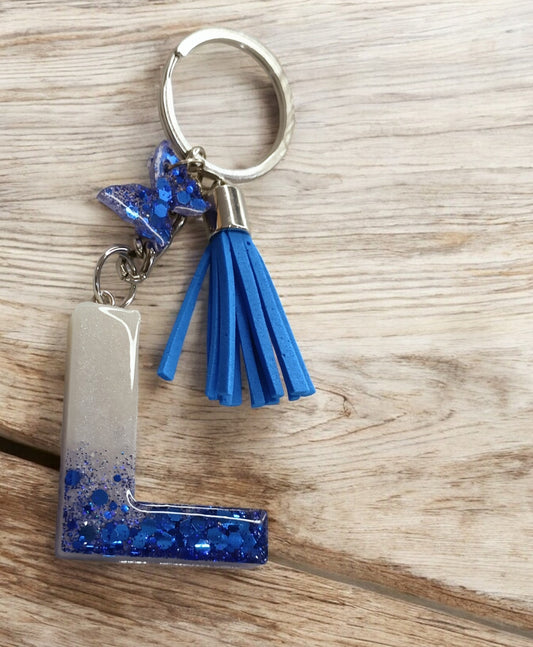 Haute Crafts Shiny Glittery  Blue & Pearl White ("L")- with small Butterfly & Tassel, Resin Alphabet Initial Letter Keychain Key Ring for Women Girls Purse Handbags, Bike, Car Keyring ("L")