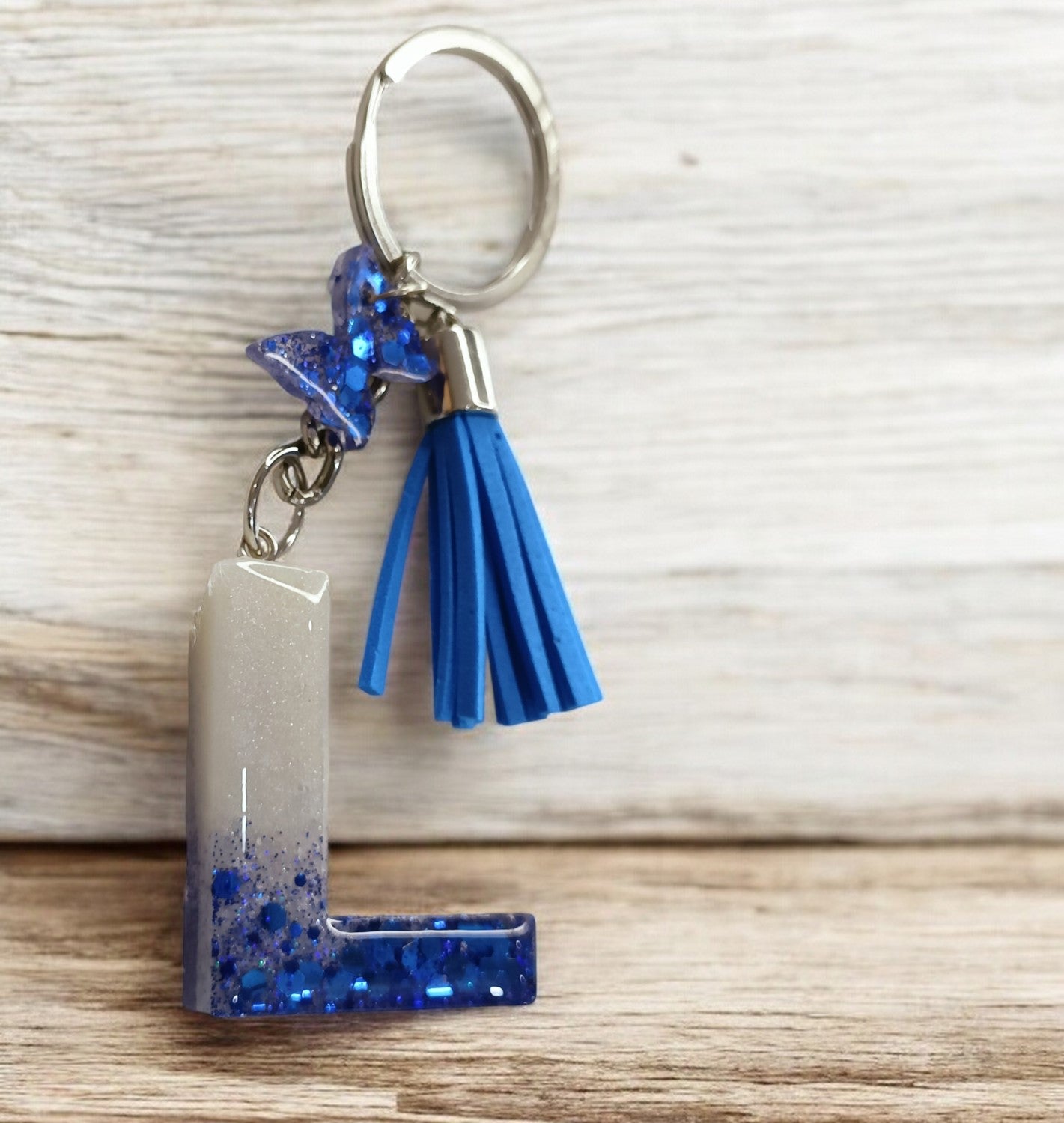 Haute Crafts Shiny Glittery Blue & Pearl White ("L")- with small Butterfly & Tassel, Resin Alphabet Initial Letter Keychain Key Ring for Women Girls Purse Handbags, Bike, Car Keyring ("L")