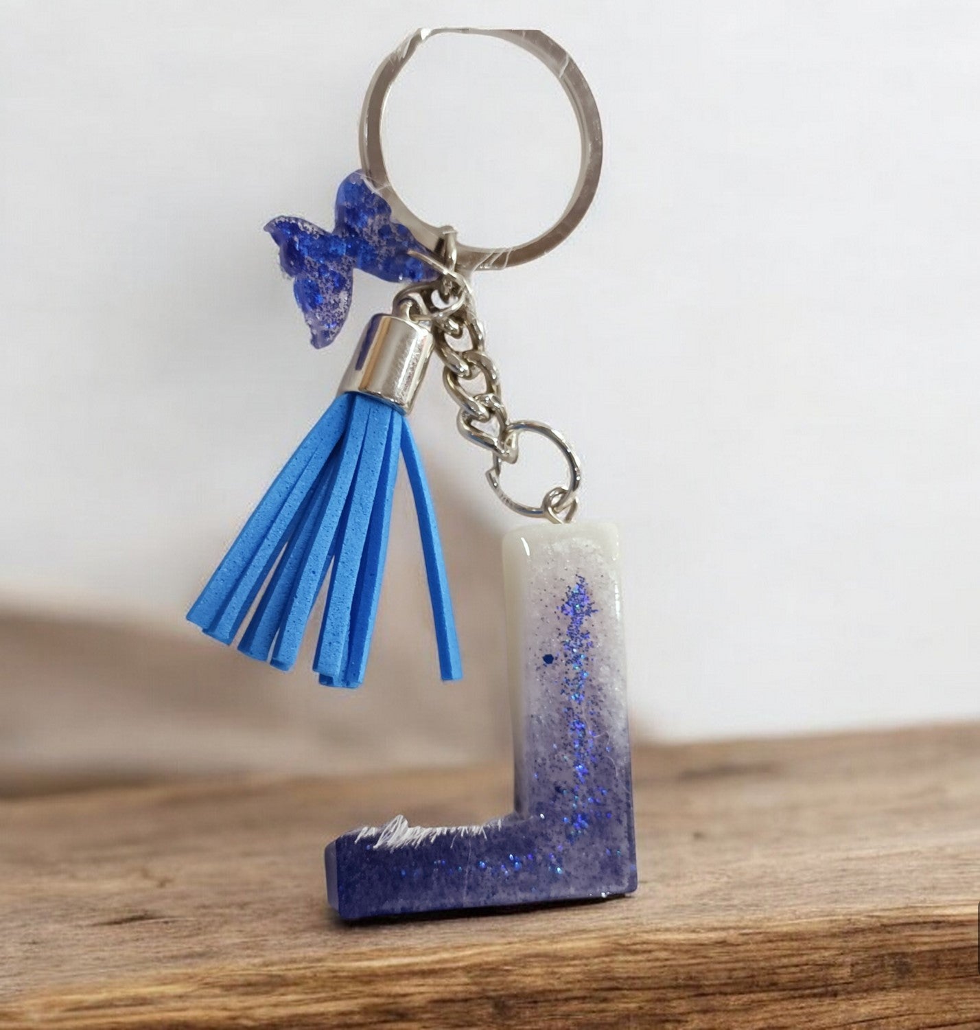 Haute Crafts Shiny Glittery Blue & Pearl White ("L")- with small Butterfly & Tassel, Resin Alphabet Initial Letter Keychain Key Ring for Women Girls Purse Handbags, Bike, Car Keyring ("L")
