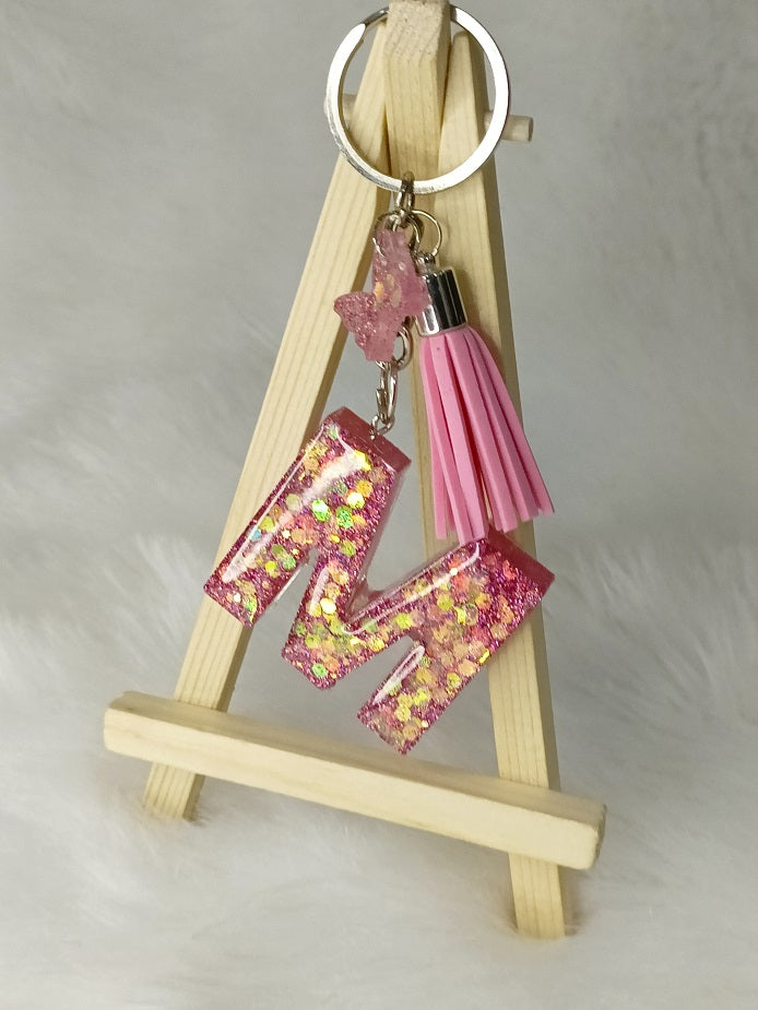 Haute Crafts Giltery Shiny Pink ("M")- with small Butterfly& Tassel, Resin Alphabet Initial Letter Keychain Key Ring for Women Girls Purse Handbags, Bike, Car Keyring ("M")