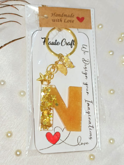 Haute Crafts Shiny Glittery Golden ("N")- with Golden star & Butterfly, Resin Alphabet Initial Letter Keychain Key Ring for Women Girls Purse Handbags, Bike, Car Keyring, Home, Small Gifts, ("N")